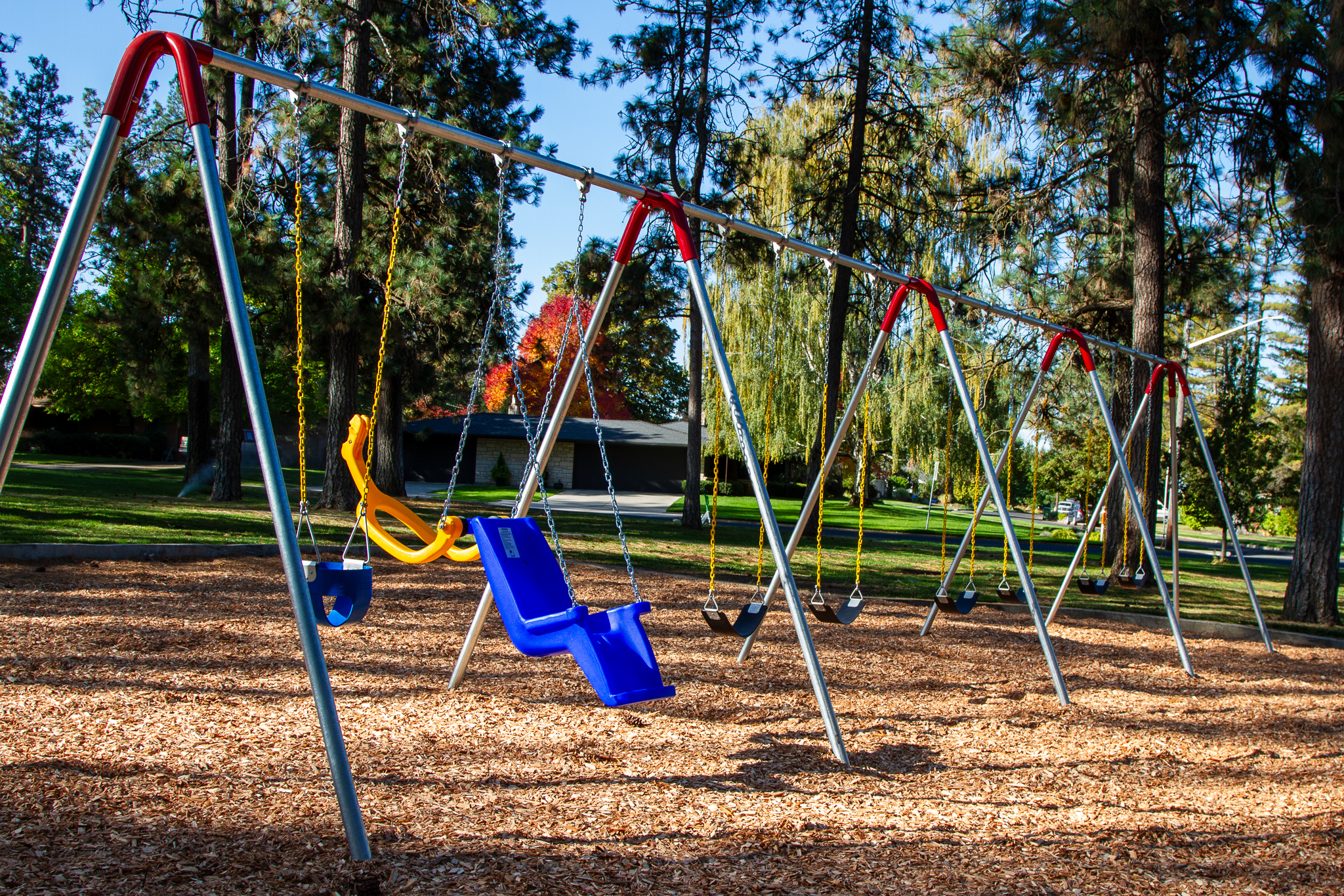 Image of an 8-seat swing set including a tot seat and an ADA-compliant seat