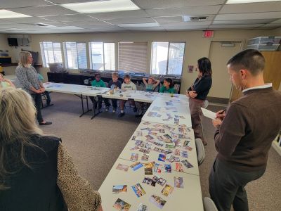 Adults listen to elementary students share design ideas for a new elementary school.
