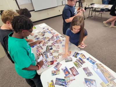 Elementary students create collages with photos, drawings and text to help design a new school. 
